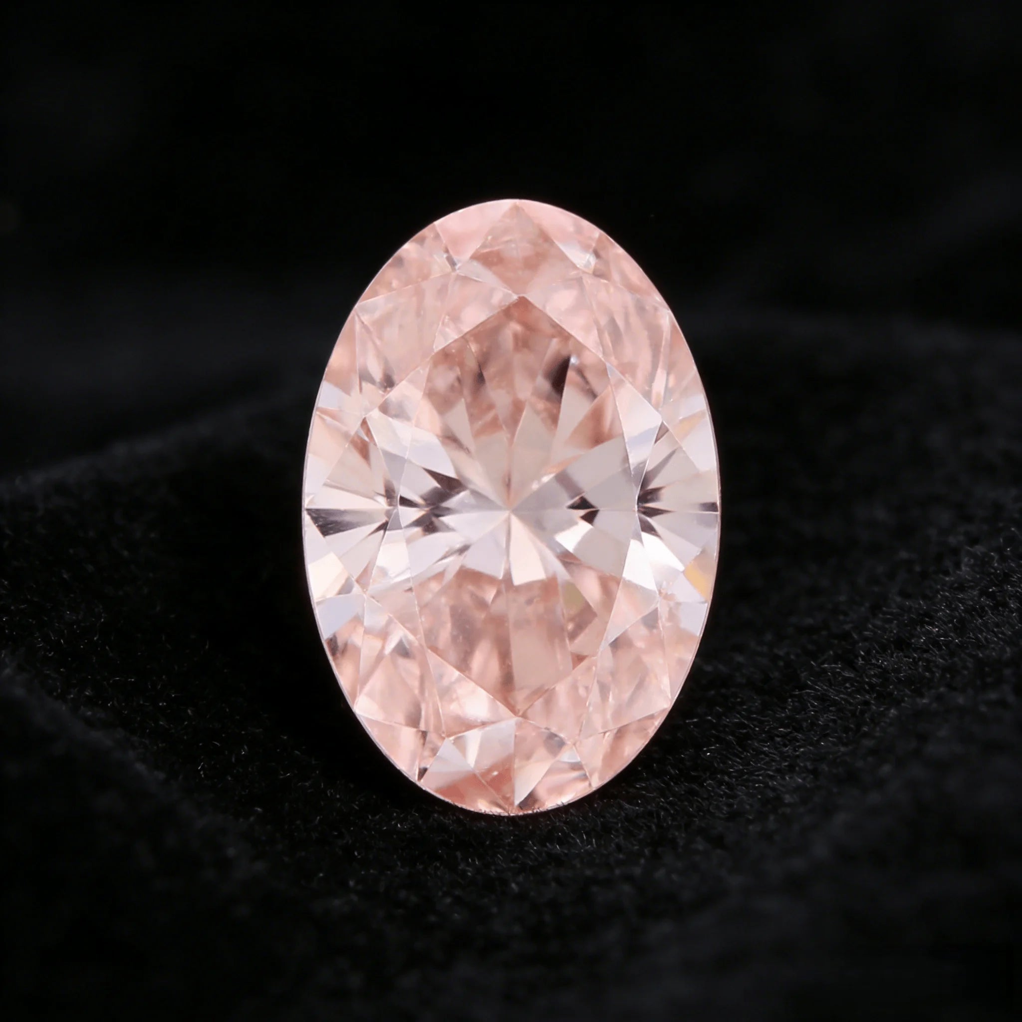 Oval fancy pink lab-grown diamond with detailed facets and bright sparkle