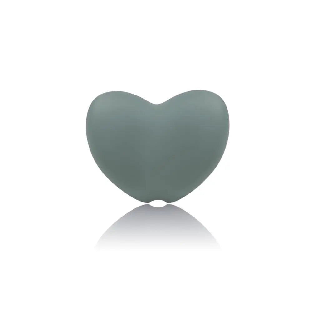Sage green heart-shaped silicone teething toy for baby teething relief.