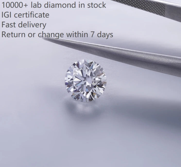 Round lab-grown diamond on white paper next to a metal pen