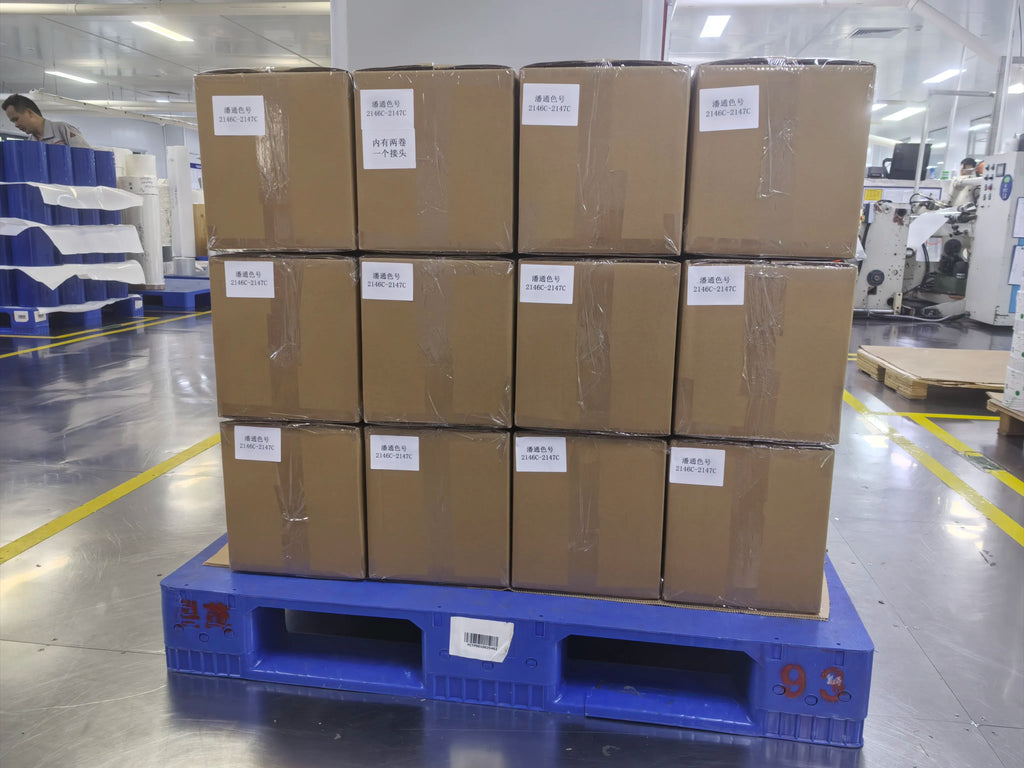 High-temperature silicone adhesive tape shipping cartons stacked on a blue pallet