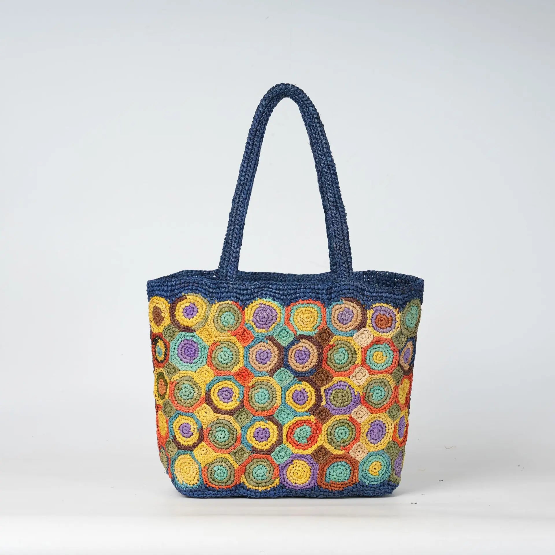 Blue woven crochet tote bag with colorful circular patterns, perfect for a durable summer beach handbag.