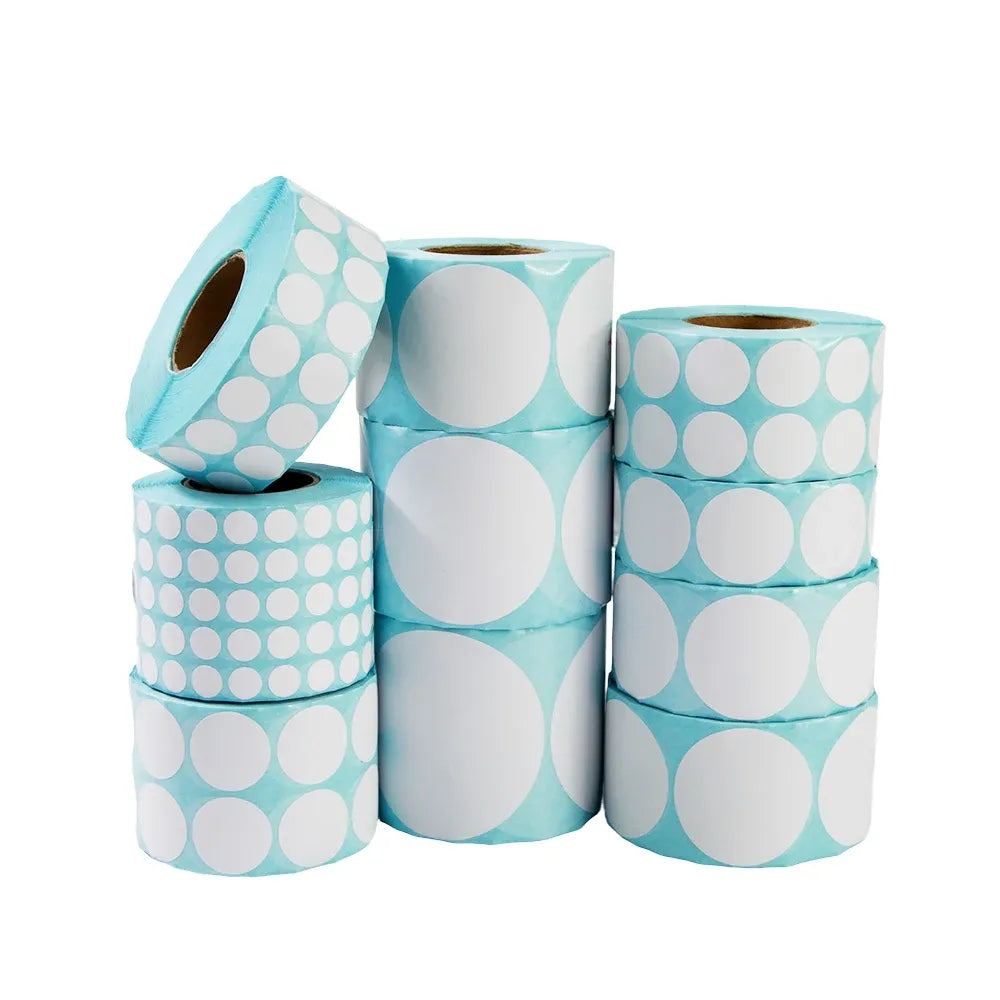Stacked rolls of blue and white circular adhesive labels with large dot pattern