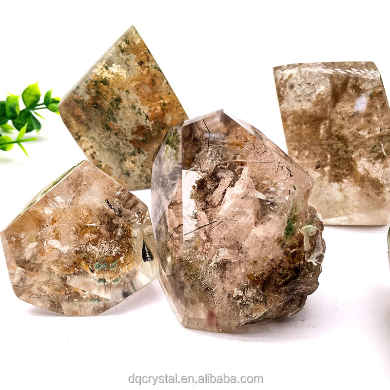 Group of polished phantom quartz free-form crystals in clear, brown and smoky tones