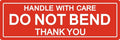 Red fragile warning label reading “HANDLE WITH CARE, DO NOT BEND, THANK YOU”