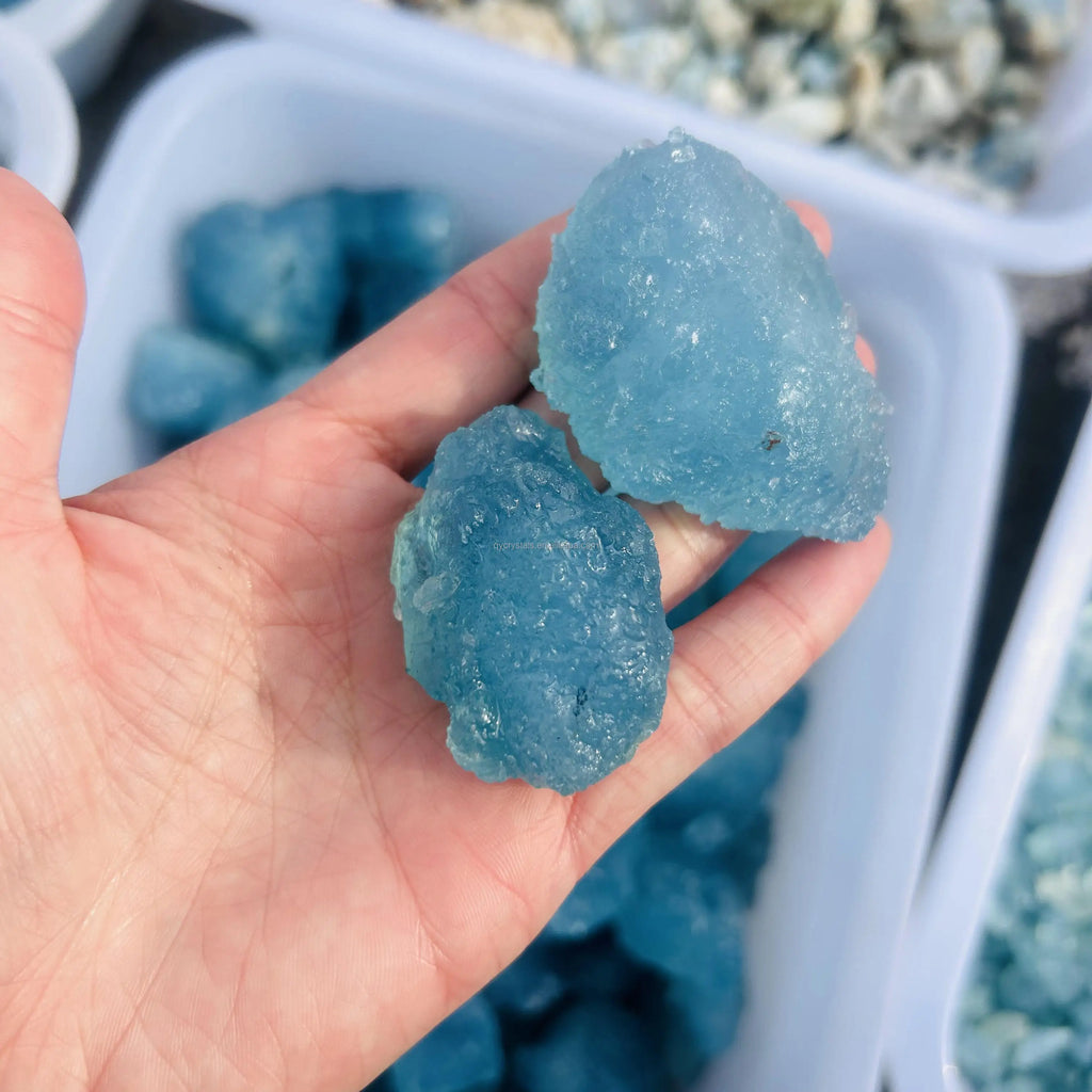 Sky blue aquamarine rough crystal stone, druzy texture, in hand