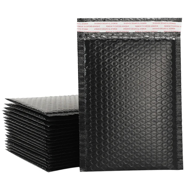 Stack of black bubble envelope bags with bubble-textured surface and sealed top