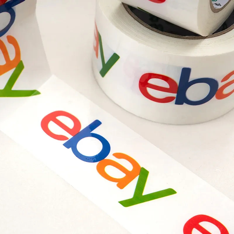 Close-up of white packing tape with colorful eBay logo lettering, roll edge visible