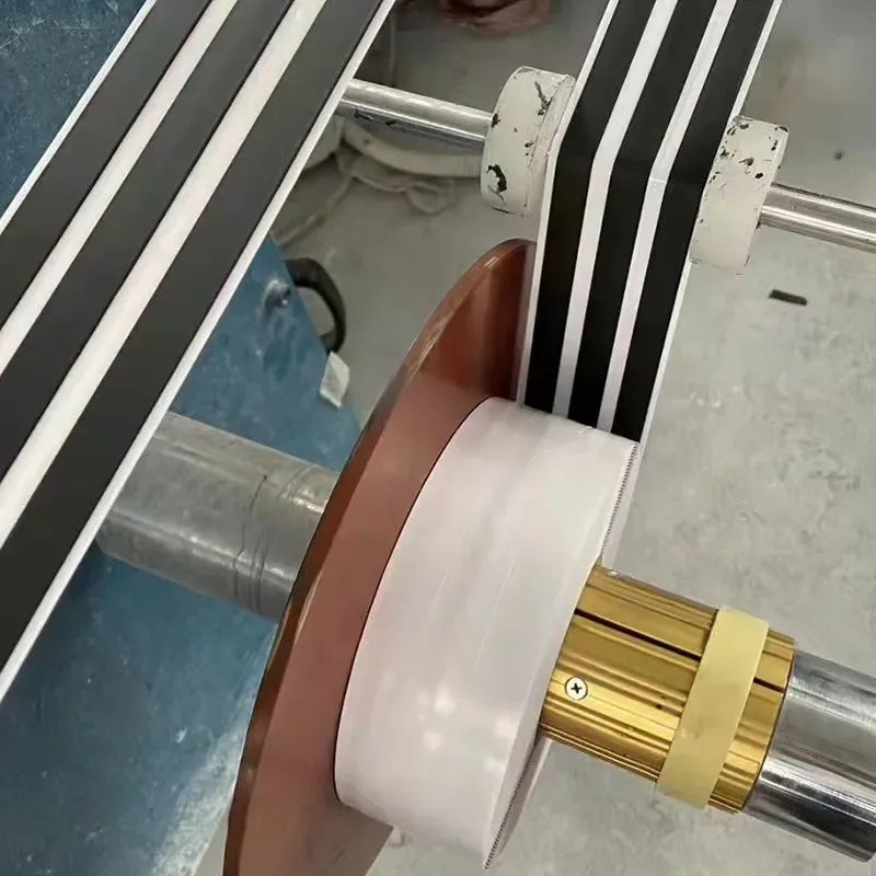 Foil sealant tape roll wrapped around a metal pipe, gray and white layers