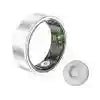 Silver smart ring with internal biometric sensors and a matching wireless charging puck.