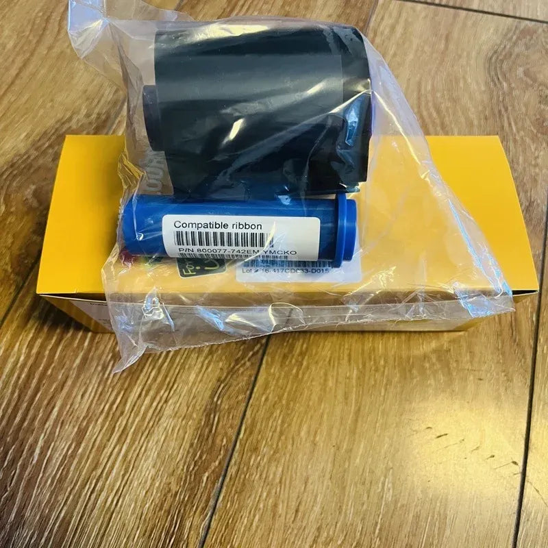 Sealed compatible ribbon pack with blue-wrapped roll and yellow box