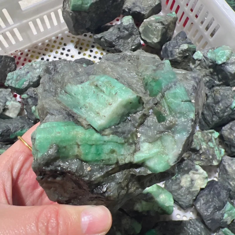 Large rough green crystal quartz piece with mint-green sections on dark gray rock