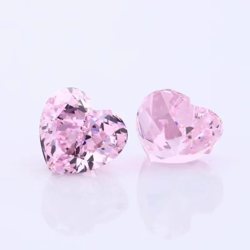 Two pink heart-shaped lab-grown diamonds, faceted loose stones