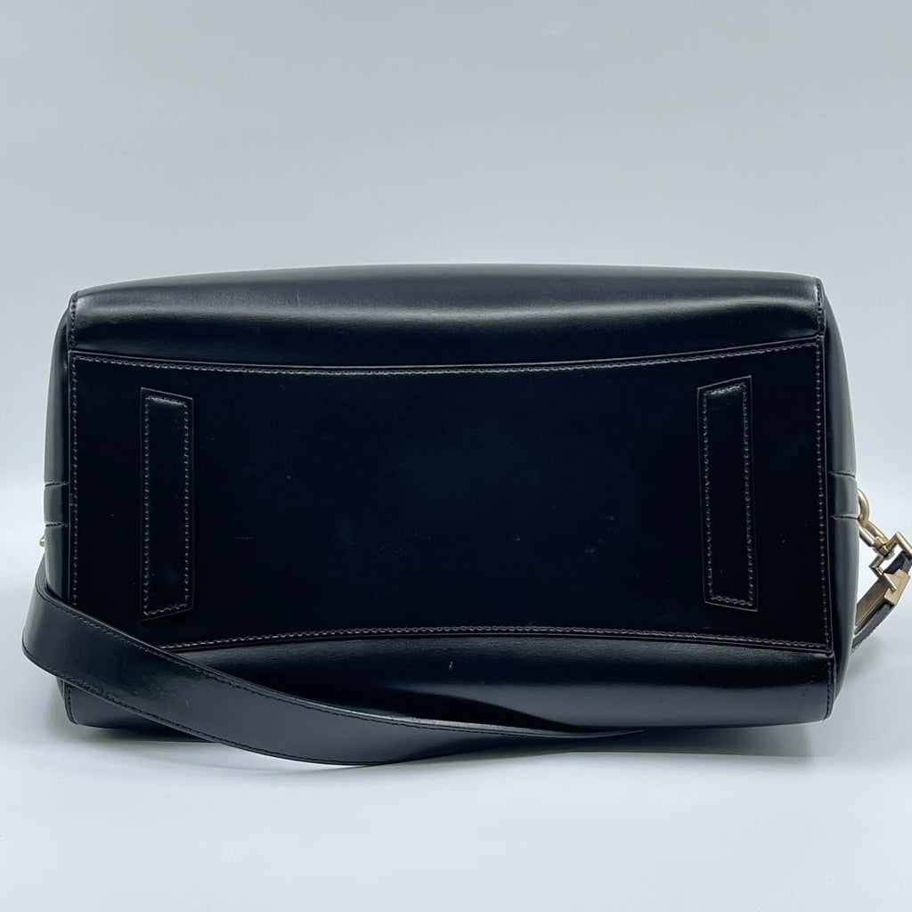 Pre-owned designer handbag in black genuine leather, vintage chic style with structured rectangular crossbody shape.