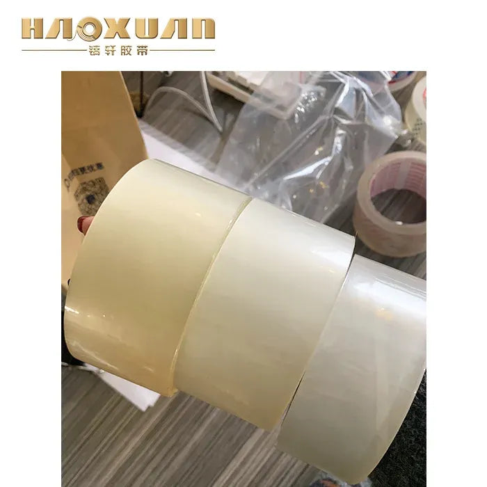 Beige packing tape roll on a clear dispenser roll