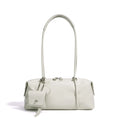 Minimalist white Boston underarm shoulder bag with luxe leather texture, silver zipper, and decorative mini pouch.