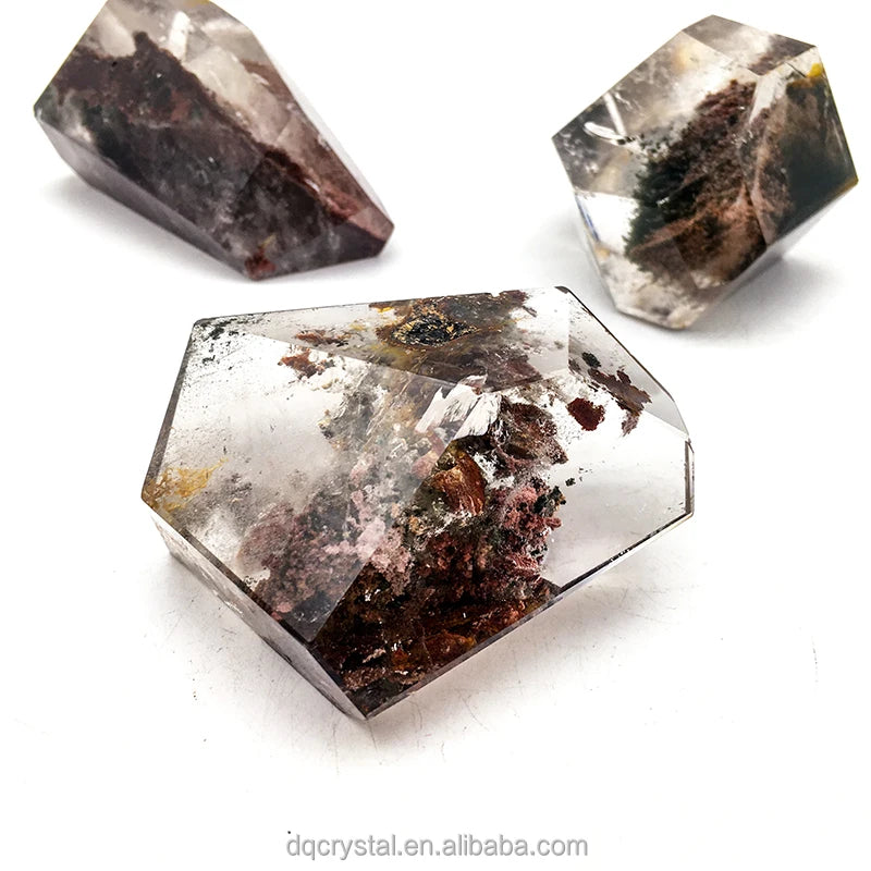 Large faceted quartz freeform with dark brown and greenish mineral inclusions