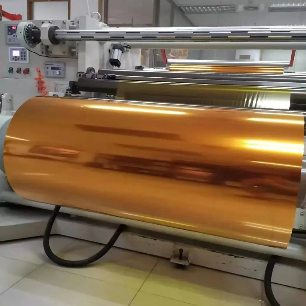 Large amber-gold roll of heat tape on an industrial winding machine
