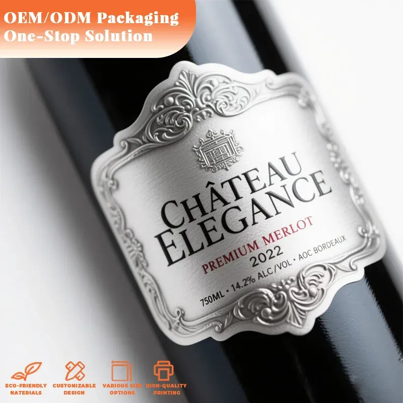Embossed silver metal bottle label with ornate frame and Chateau Elegance text