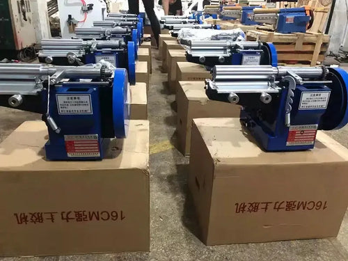 Pair of blue glue gluing machines on workbench with rollers and control units, MG-553