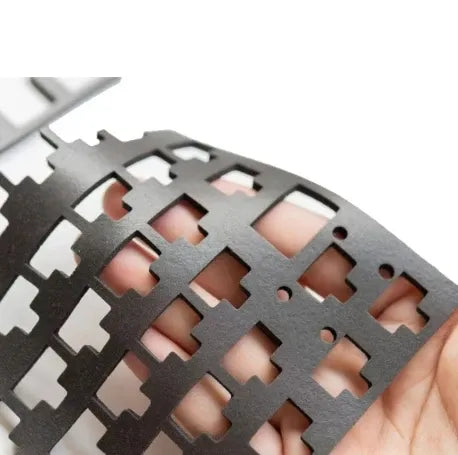 Black foam tape grid with rectangular cutouts held in hand
