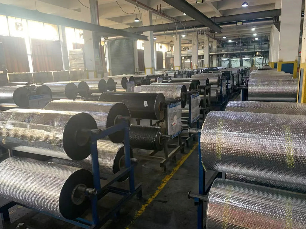 Wax thermal transfer ribbon rolls mounted on machine, silver backing on black cores