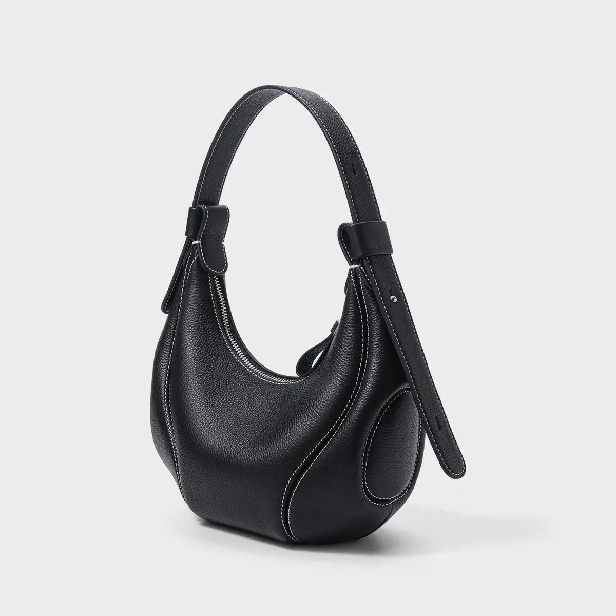 Black pebbled leather half moon handbag with white contrast stitching, shoulder strap, and top zipper.