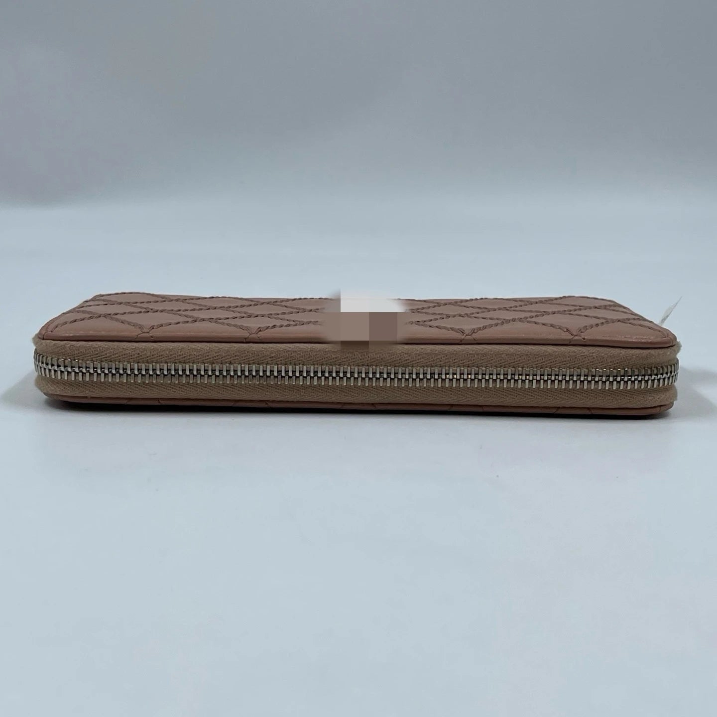 Beige quilted genuine leather designer clutch wallet with silver zip closure, luxury wholesale fashion accessory.