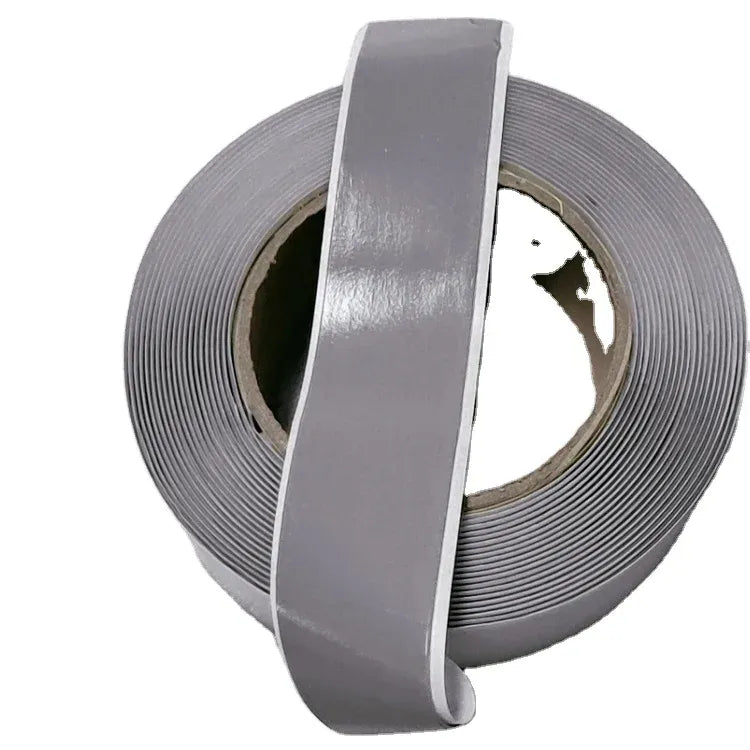 Gray foil-backed sealant tape roll with cut outer strip and inner core showing