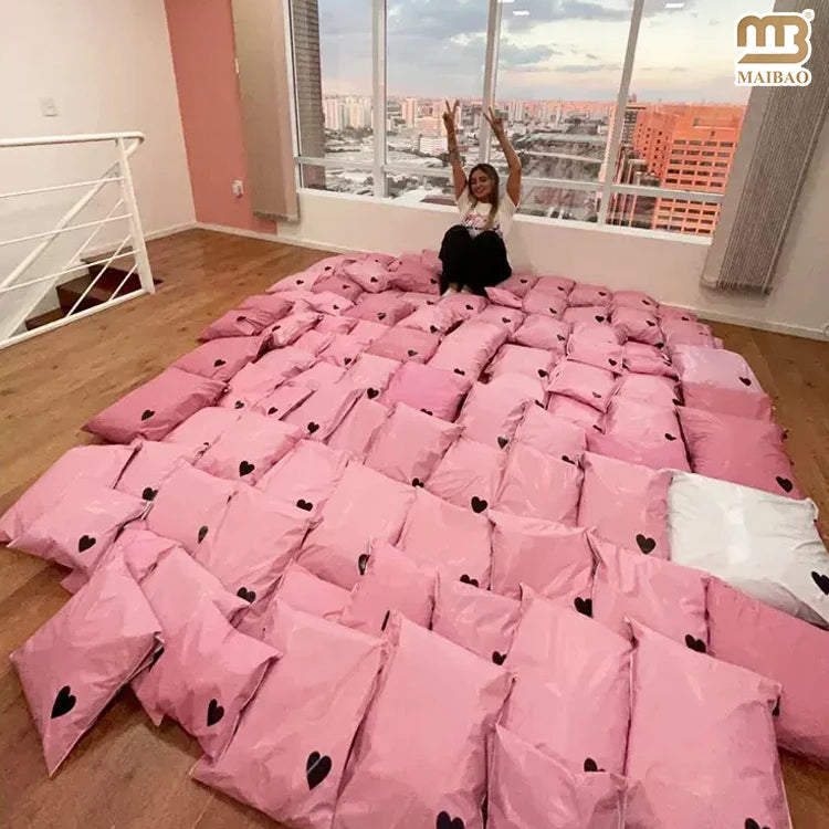 Pink poly mailer bag with small black heart print