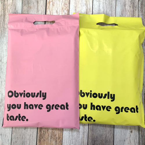 Pink and yellow mailing bags with built-in handle cutout