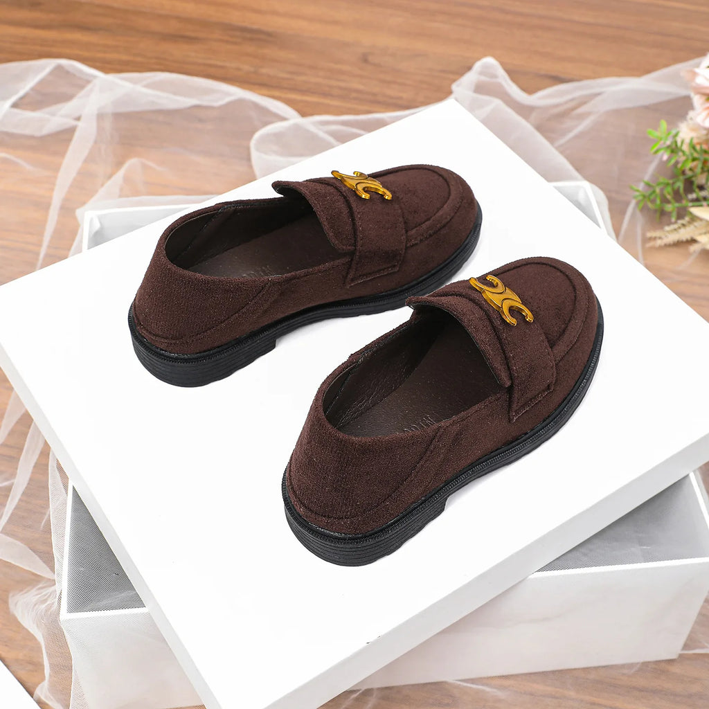 Dark brown suede women's luxury loafers with gold metal detail, round toe, and black flat rubber sole on white display.