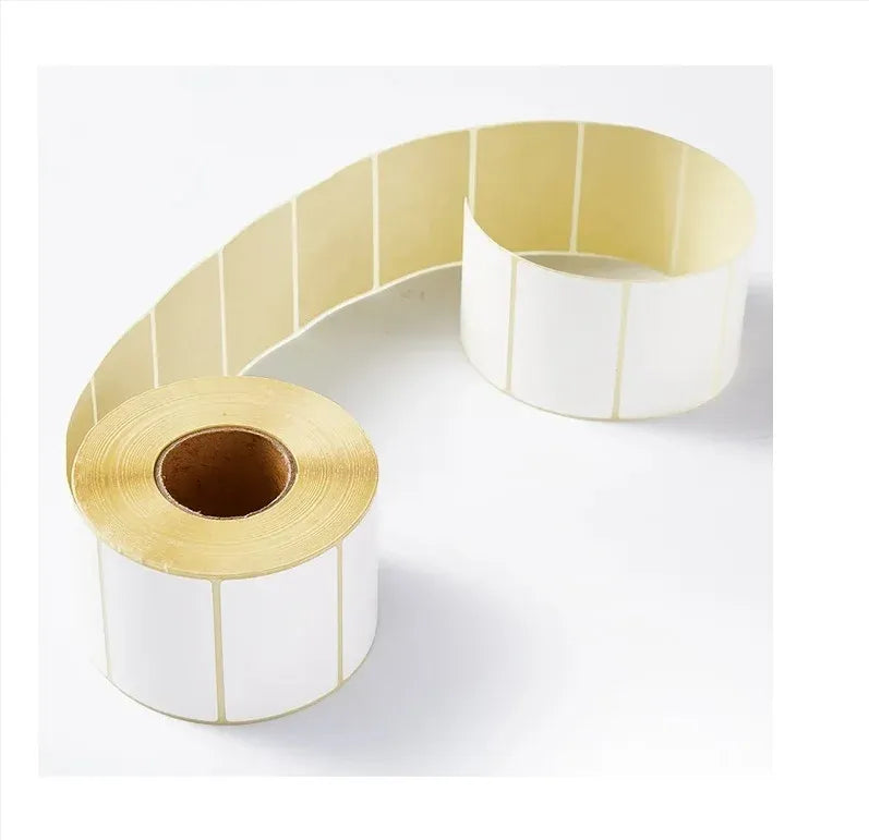 White and pale-yellow label sticker roll with continuous strip wound into a coil