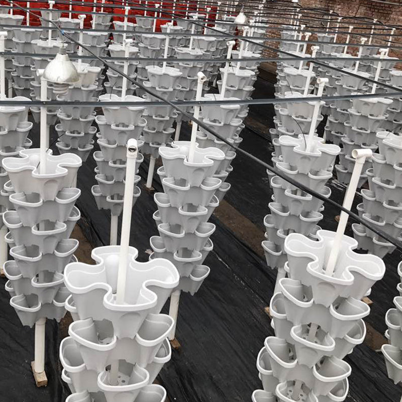 Bulk stackable vertical plant pot towers with white plastic cups arranged in rows