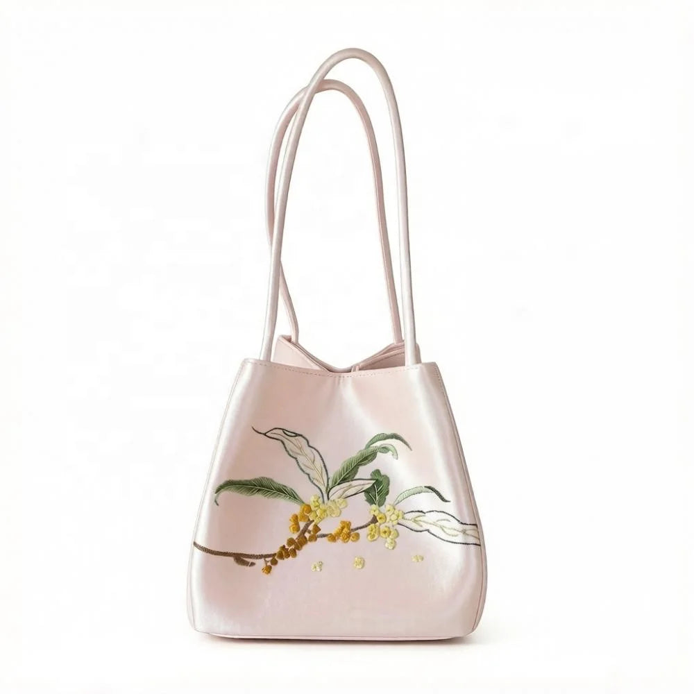 Lightweight pale pink Suzhou embroidery purse with floral branch design and long shoulder straps.