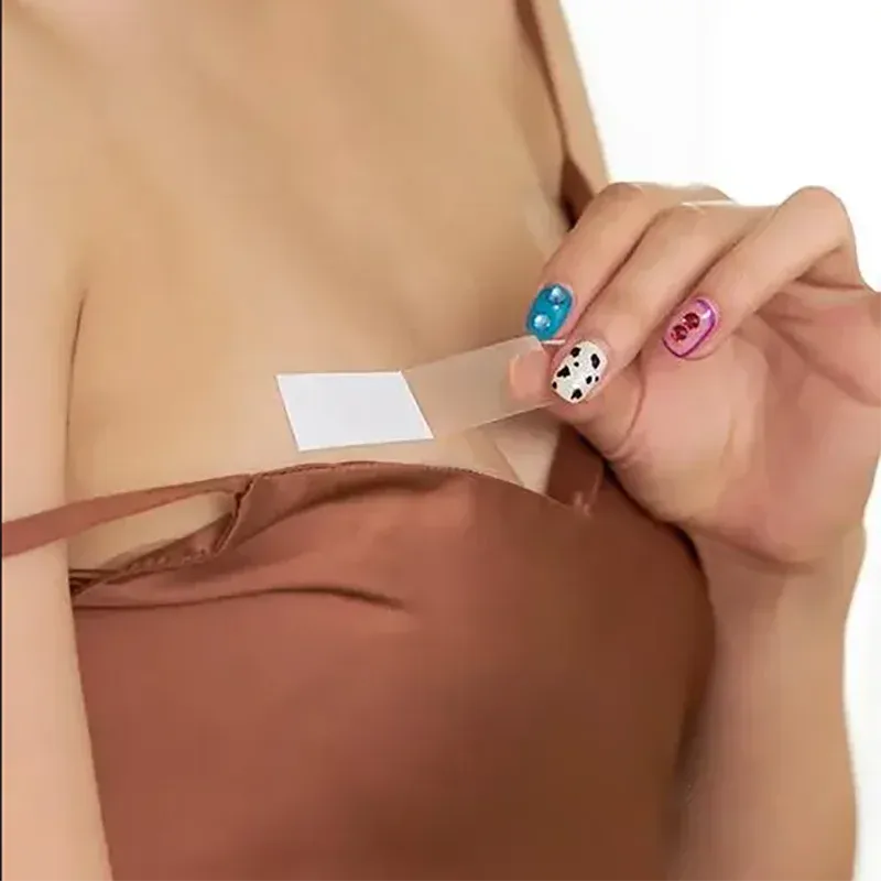 Transparent tape strip securing fabric along a neckline area