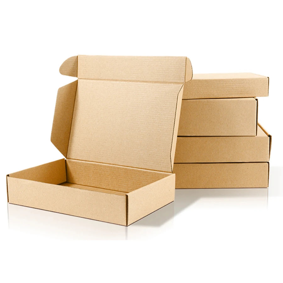 Brown kraft shipping mailer boxes, open flaps and stacked inserts for packing.