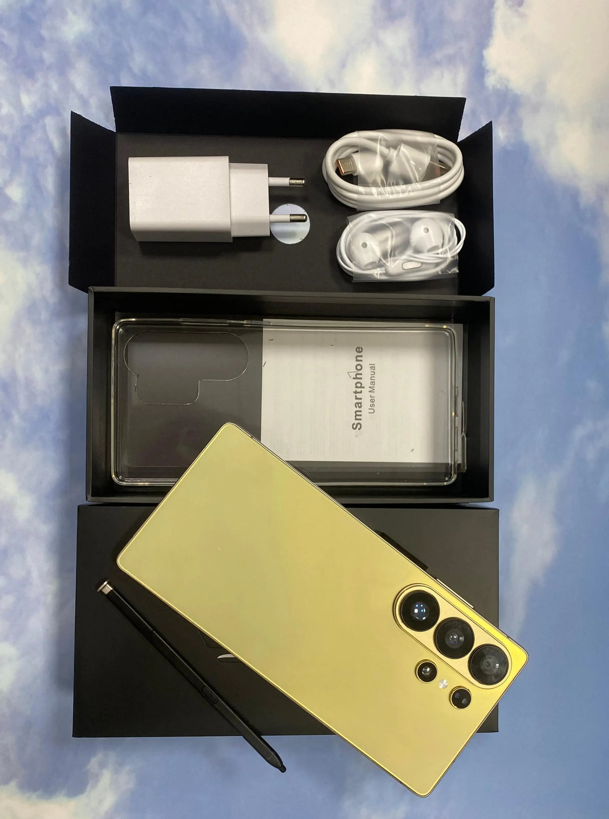 Yellow smartphone and built-in pen with accessories in open box packaging