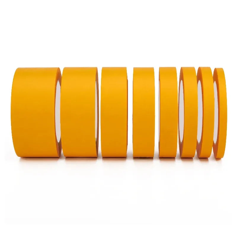 Yellow masking tape jumbo rolls stacked, showing multiple roll layers