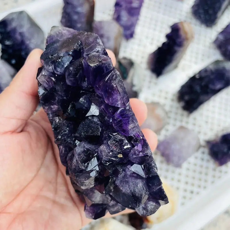 Purple amethyst crystal cluster point with dark druzy texture