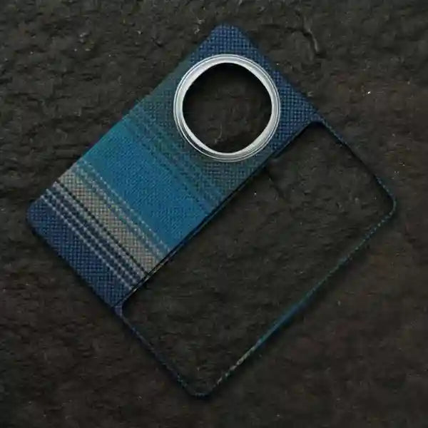 Blue plaid camera lens cover for a smartphone with a circular silver metal ring cutout.