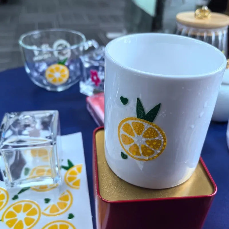 Round vinyl lemon sticker on white cup with green leaves and yellow citrus