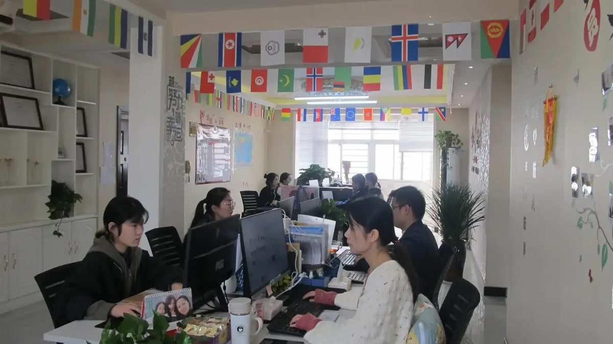 Group working at computers in an office with retail barcode weighing scale setup