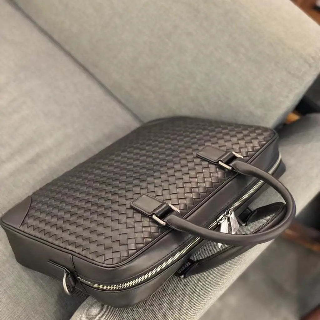 Black hand-woven genuine leather men's executive briefcase laptop bag with dual handles and silver zipper hardware.