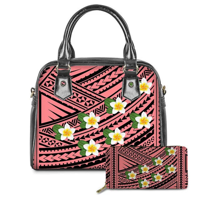 Pink leather handbag and wallet set with black Polynesian tribal patterns and white plumeria flower prints.