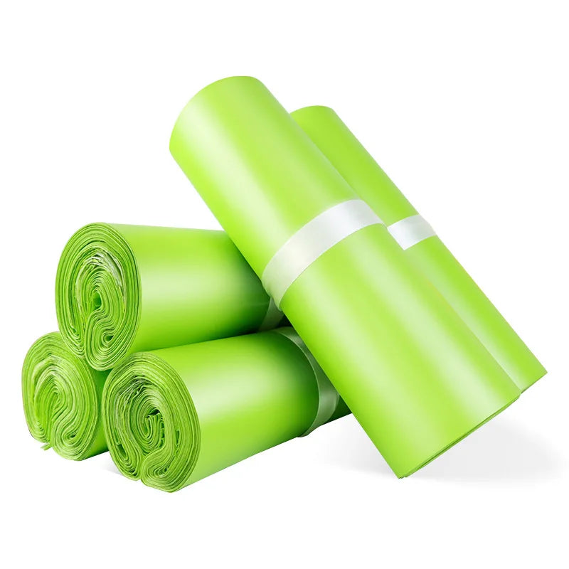 Green plastic shipping mailer rolls, bundled with striped band