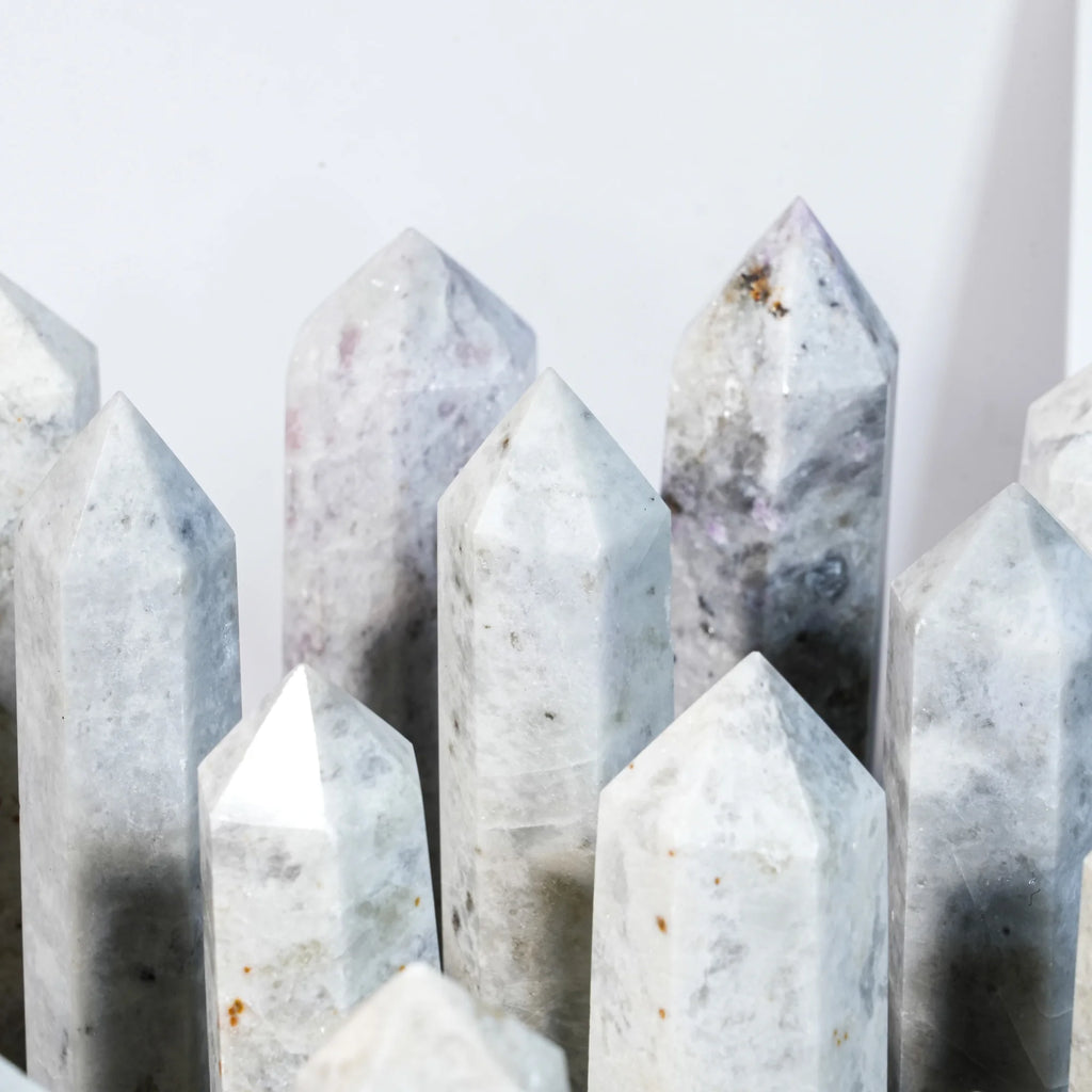 Close-up of natural gemstone crystal point tower showing tall pointed stones.