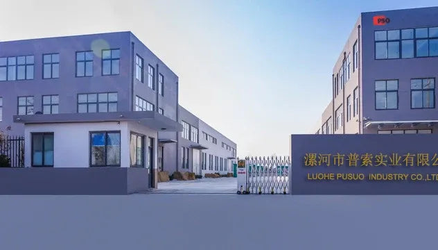 Industrial facility exterior with fenced yard and multi-story warehouse buildings