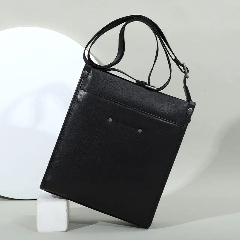 Black genuine leather waterproof crossbody tote, minimalist business casual shoulder bag with silver rivet details.