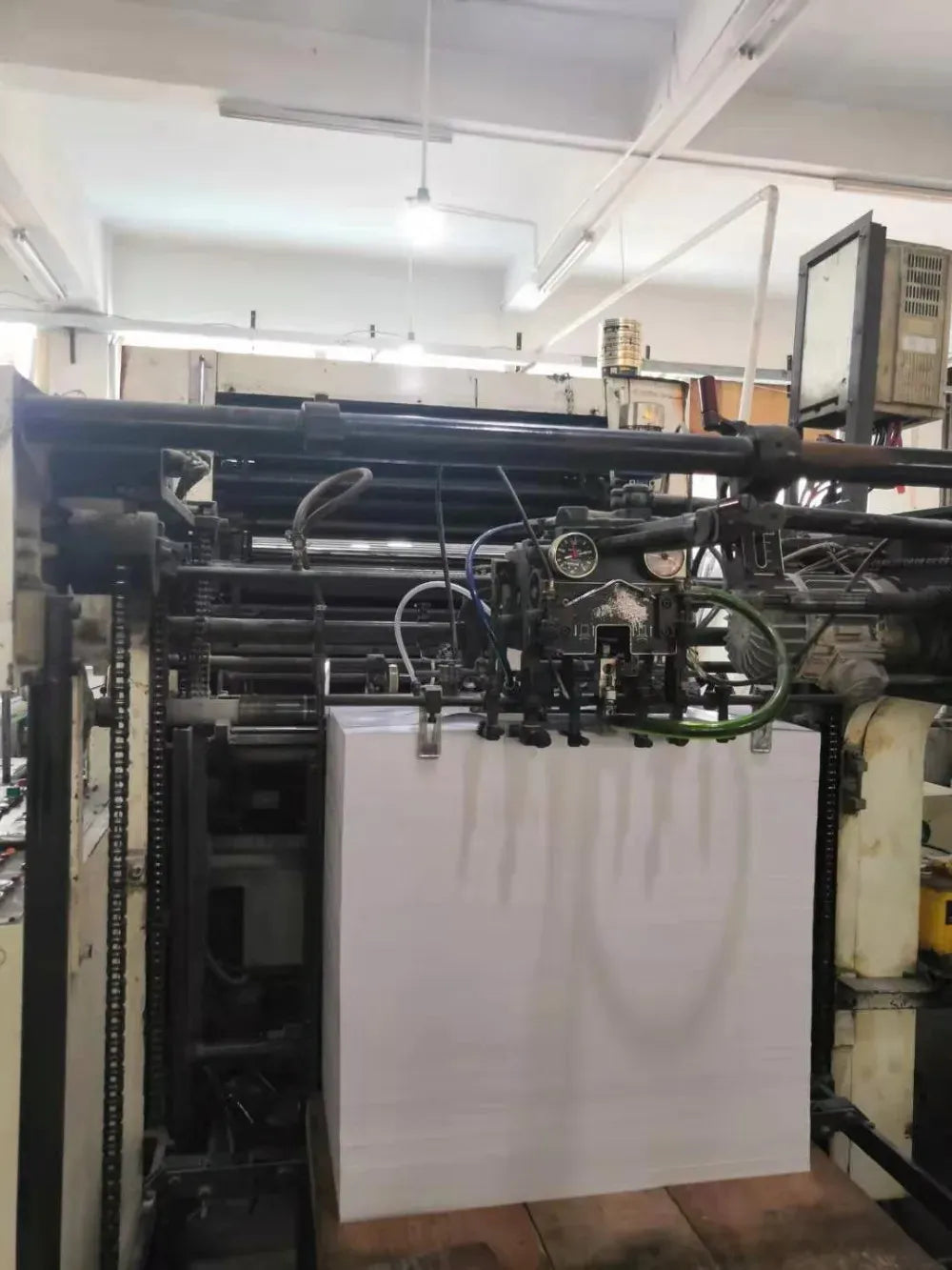 Large factory printing press producing sticker sheets for floor signage