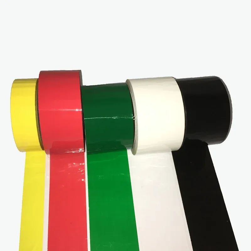 Colored acrylic carton sealing tape overlapping strips in yellow, red, green, white, and black